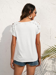 White t-shirt with lace shoulder detail and short sleeves.