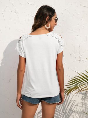White t-shirt with lace shoulder detail and short sleeves.