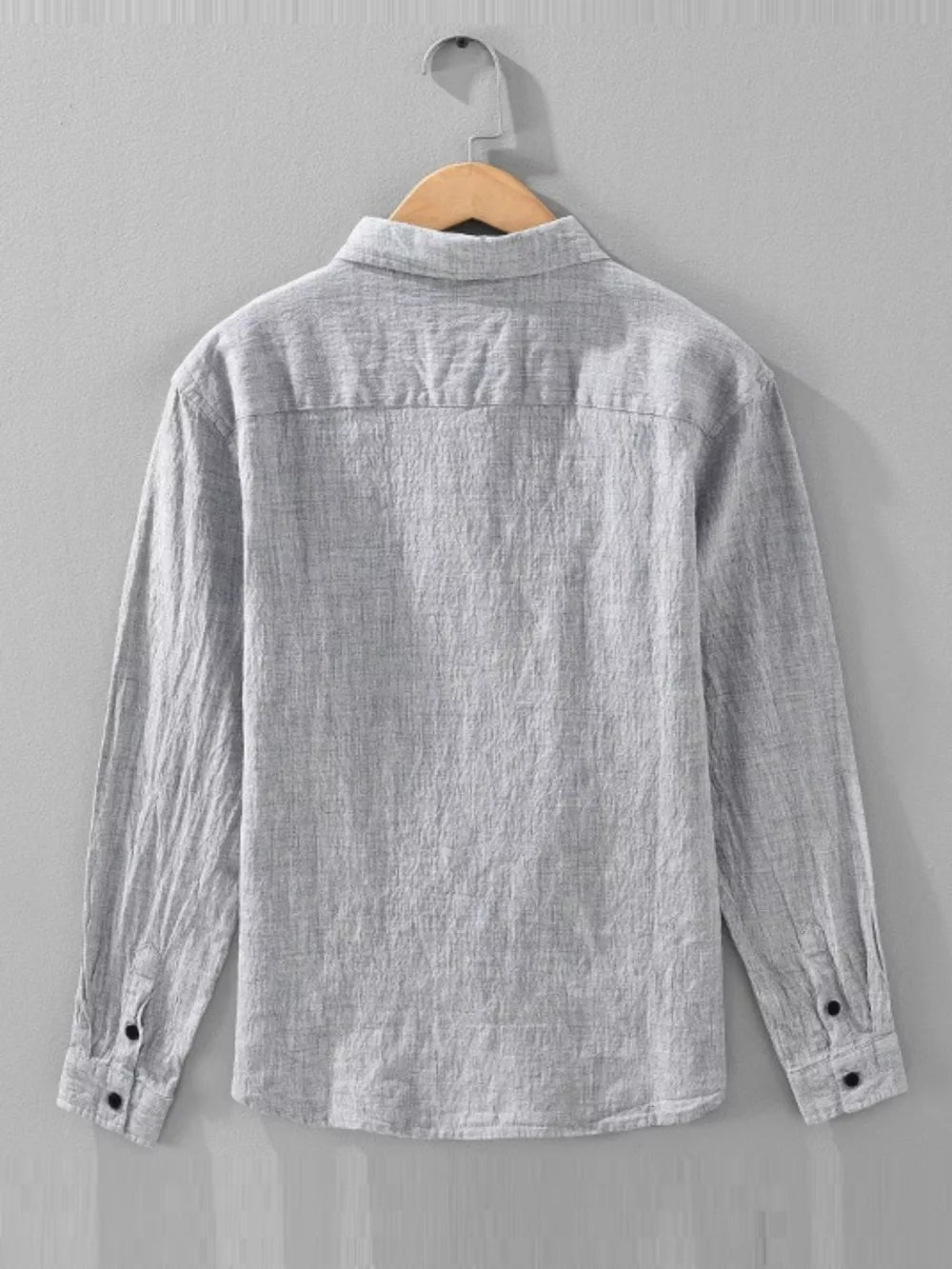 Grey linen textured long sleeve button-up shirt with button cuffs.