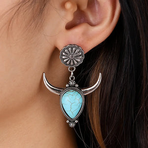 Southwestern crescent drop earrings with turquoise stone and silver alloy bull horns.