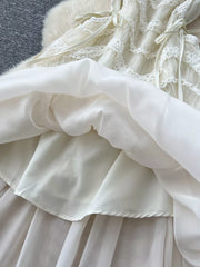 Tiered lace midi dress with bow detail, showing layered skirt and delicate fabric.