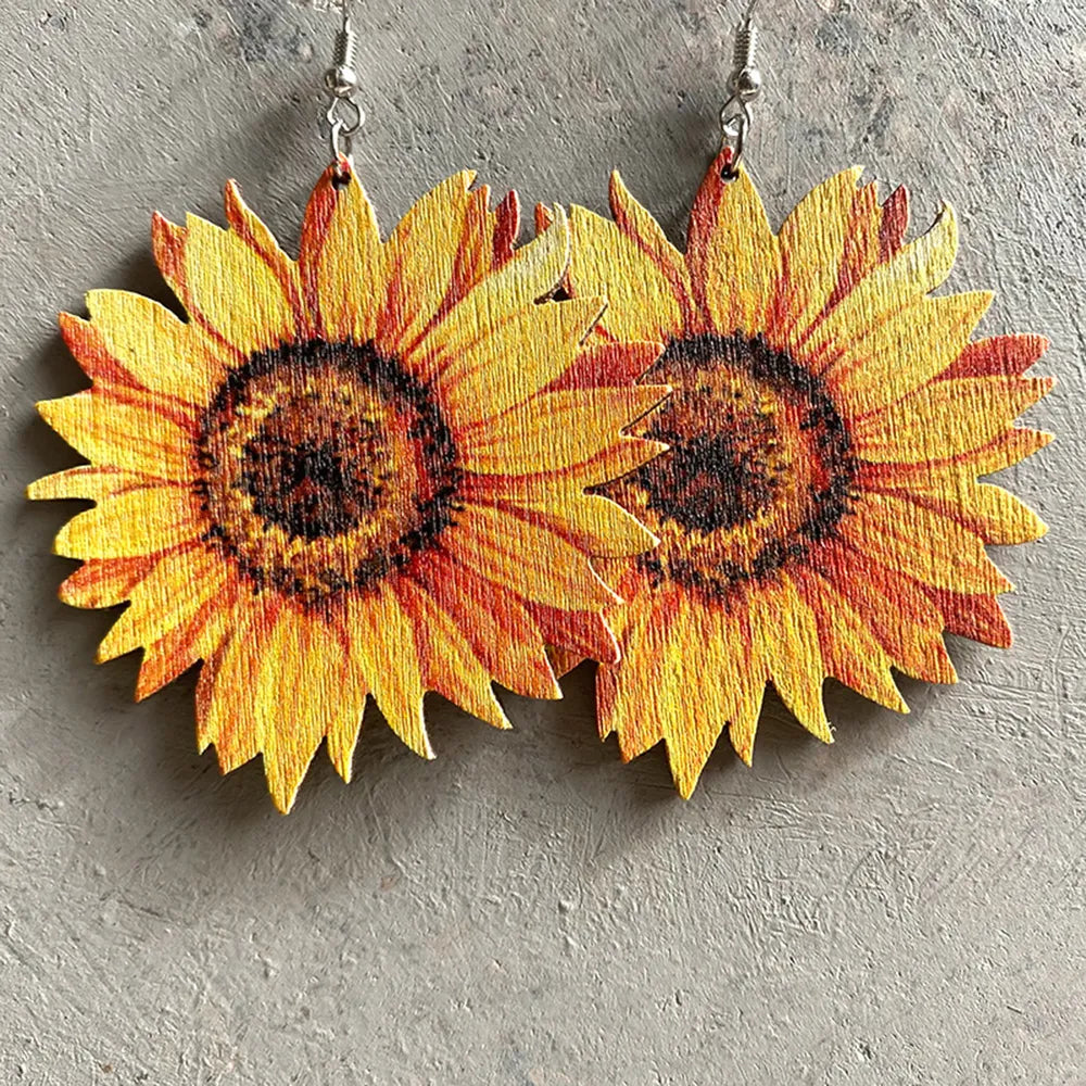 Sunflower drop earrings with detailed yellow and orange petals and brown centers.