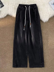 Black wide-leg drawstring jeans with a relaxed fit and denim material.