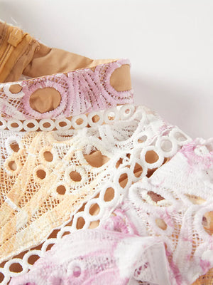 Luxe floral lace maxi gown detail with pink, purple, and yellow accents.
