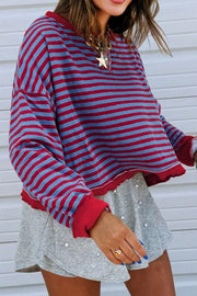 Striped sweatshirt with red and blue stripes, crew neck, and contrast red trim.