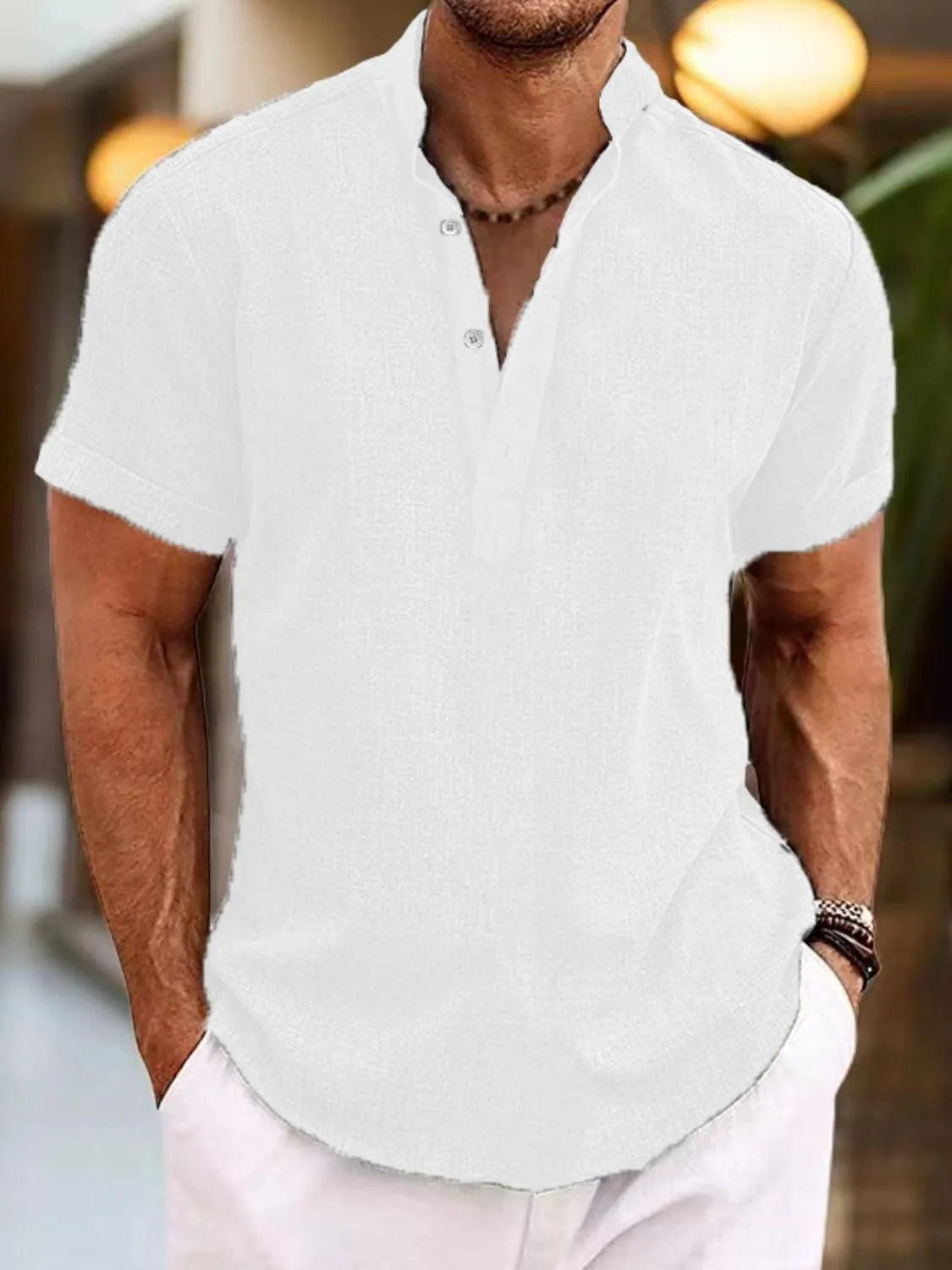 White linen blend henley shirt with mandarin collar and short sleeves.