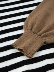 Colorblock striped knit sweater with brown sleeve detail and ribbed cuff.