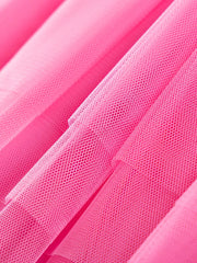 Pink tulle toddler dress fabric detail, showing mesh texture.
