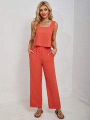 Orange cropped tank top and palazzo pants set with square neckline and wide legs.