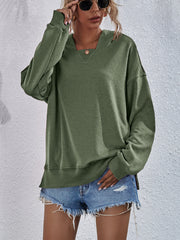 Moss green boxy hooded sweatshirt with split hem and v-neck detail.