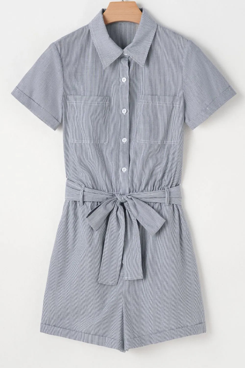 Pinstripe shirred waist romper with tie, short sleeves, collared, button front, two chest pockets.