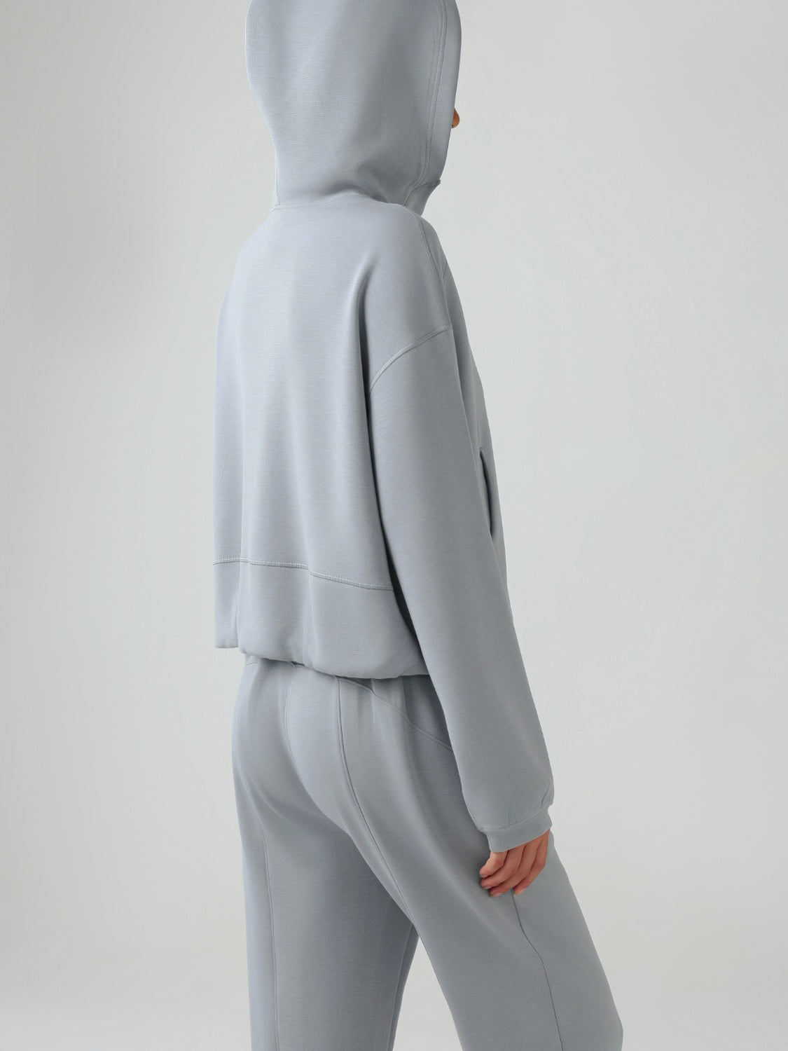 Gray cropped active hoodie with raglan sleeves and a drawstring hood.