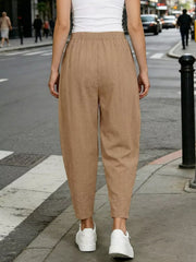 Camel harem maternity joggers with elastic waist and pockets, styled with white sneakers.