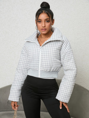 White houndstooth padded jacket with a cropped fit and high collar, zipped front.