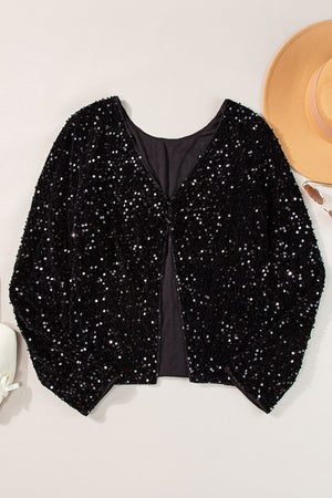 Black sequin backless blouse with V-neck and long sleeves.