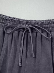 Maternity cropped wide-leg cotton pants in charcoal grey with drawstring waist and elastic waistband.