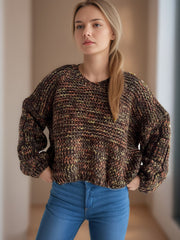 Textured knit sweater with balloon sleeves in a multi-color brown, yellow, and orange marled pattern.