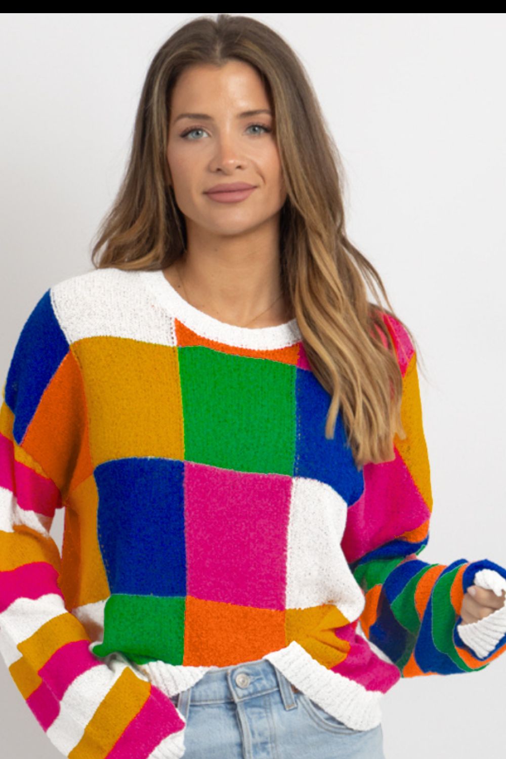 Patchwork knit crewneck pullover sweater with colorful blocks and stripes.