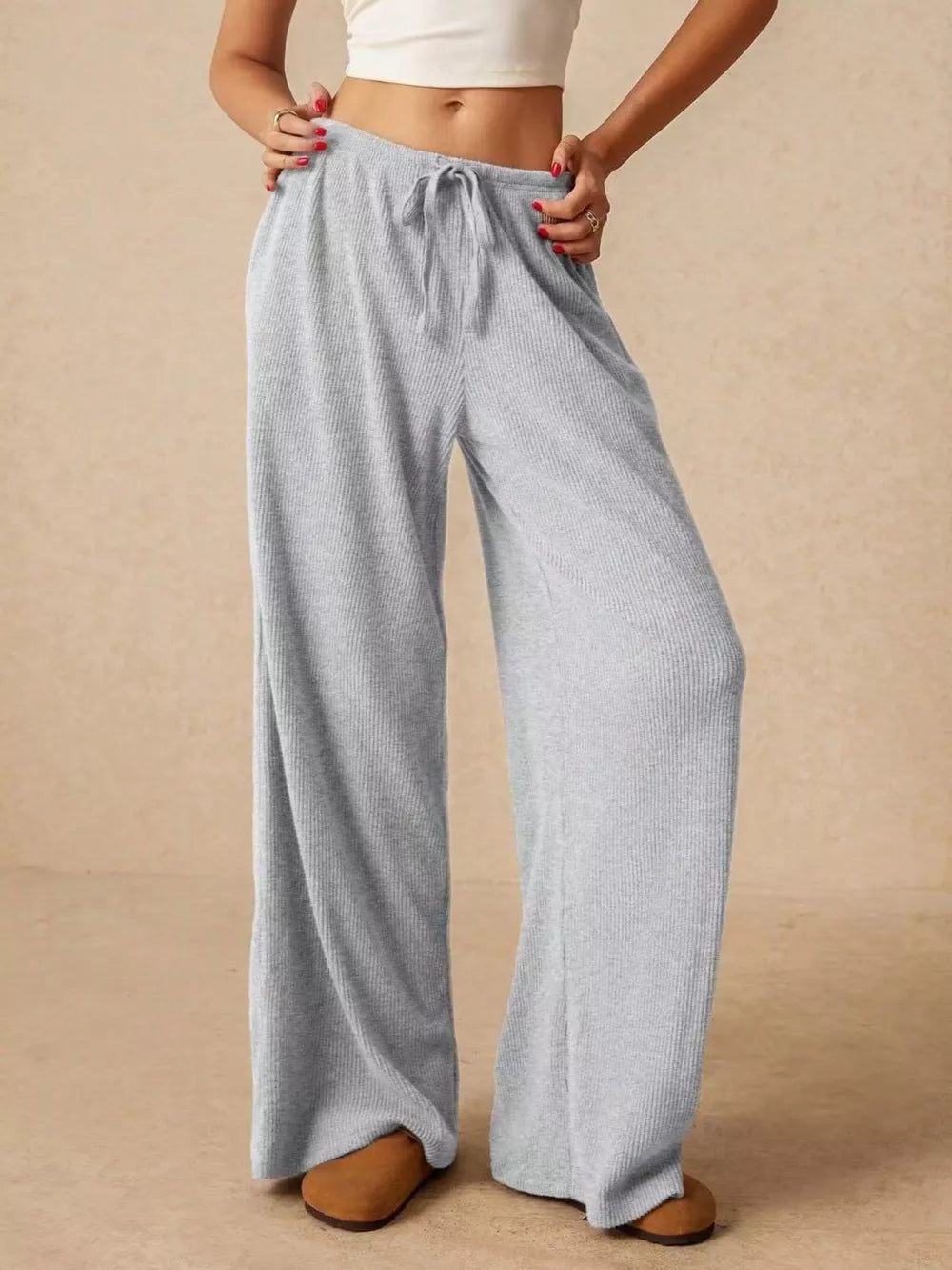 Gray ribbed wide-leg drawstring pants with a relaxed fit.