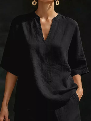 Black notched V-neck two-piece set with pockets and short sleeves.