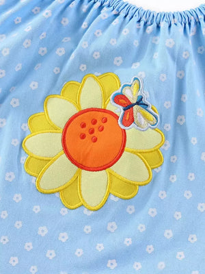 Baby dress with embroidered sunflower and butterfly detail on light blue floral print cotton fabric.