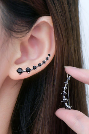 Black diamond ear climbers with a curved design, showcasing multiple black stones on a silver setting.