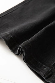 Black denim midi skirt detail showing fabric texture and stitching.
