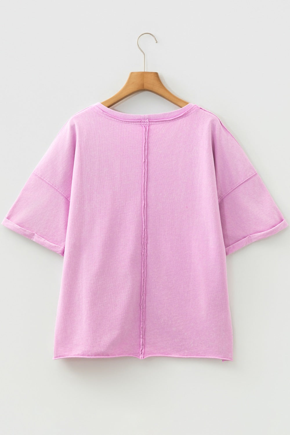 Pink cotton crew neck t-shirt with rolled sleeves and contrast stitching detail.
