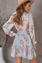 Light Mauve floral print mini dress with smocked waist and ruffled hem.