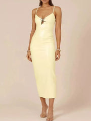 Apricot cami dress with V-neck and metal detail, midi length.