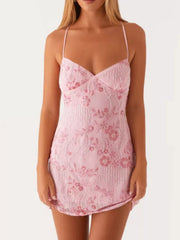 Blush pink embellished floral mini dress with beaded details and spaghetti straps.