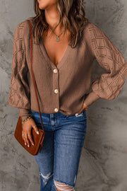 Taupe diamond-cut sleeve knit cardigan with button front and V-neck.