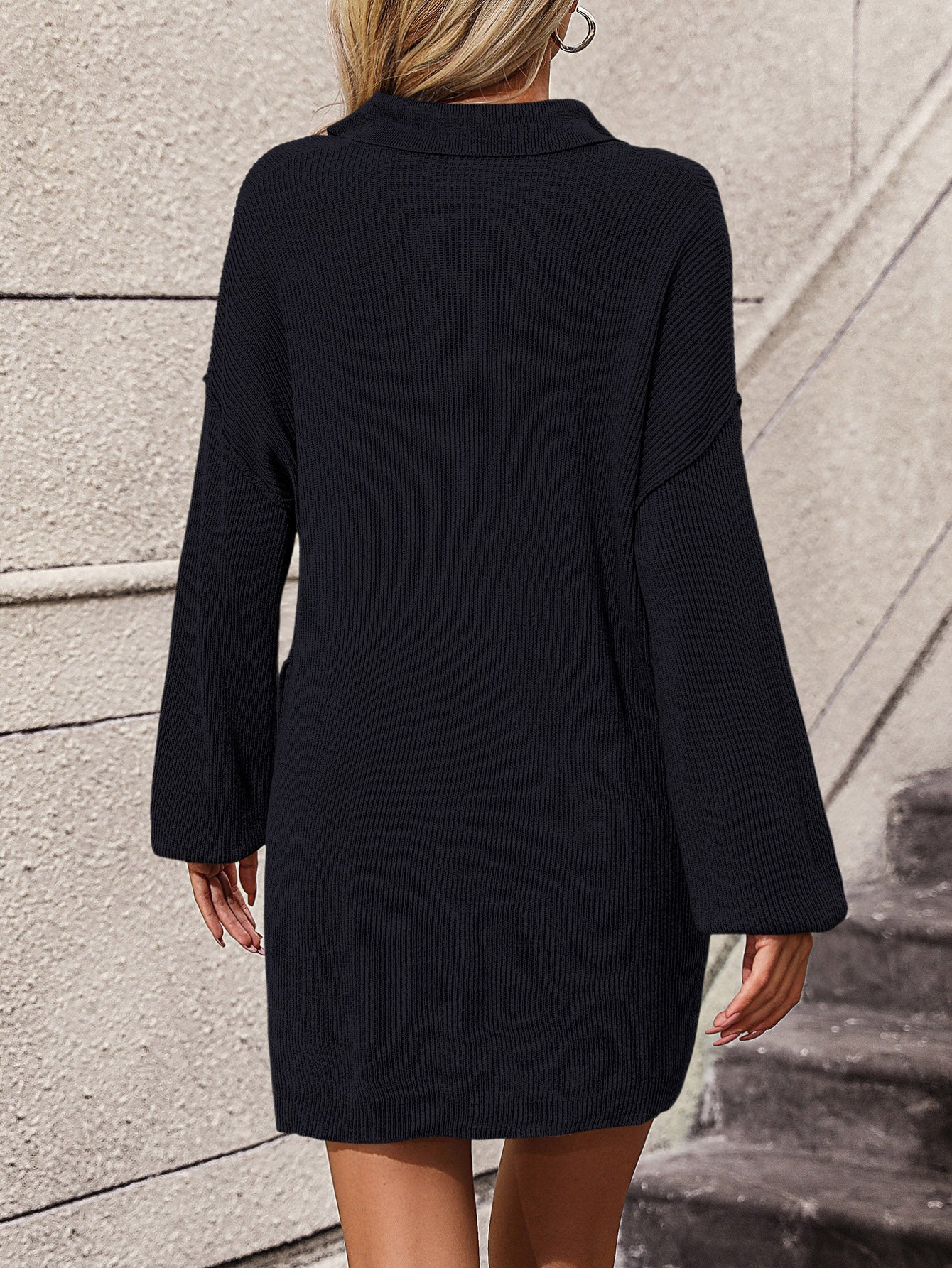 Black ribbed knit polo dress with long sleeves and pockets, acrylic fabric.