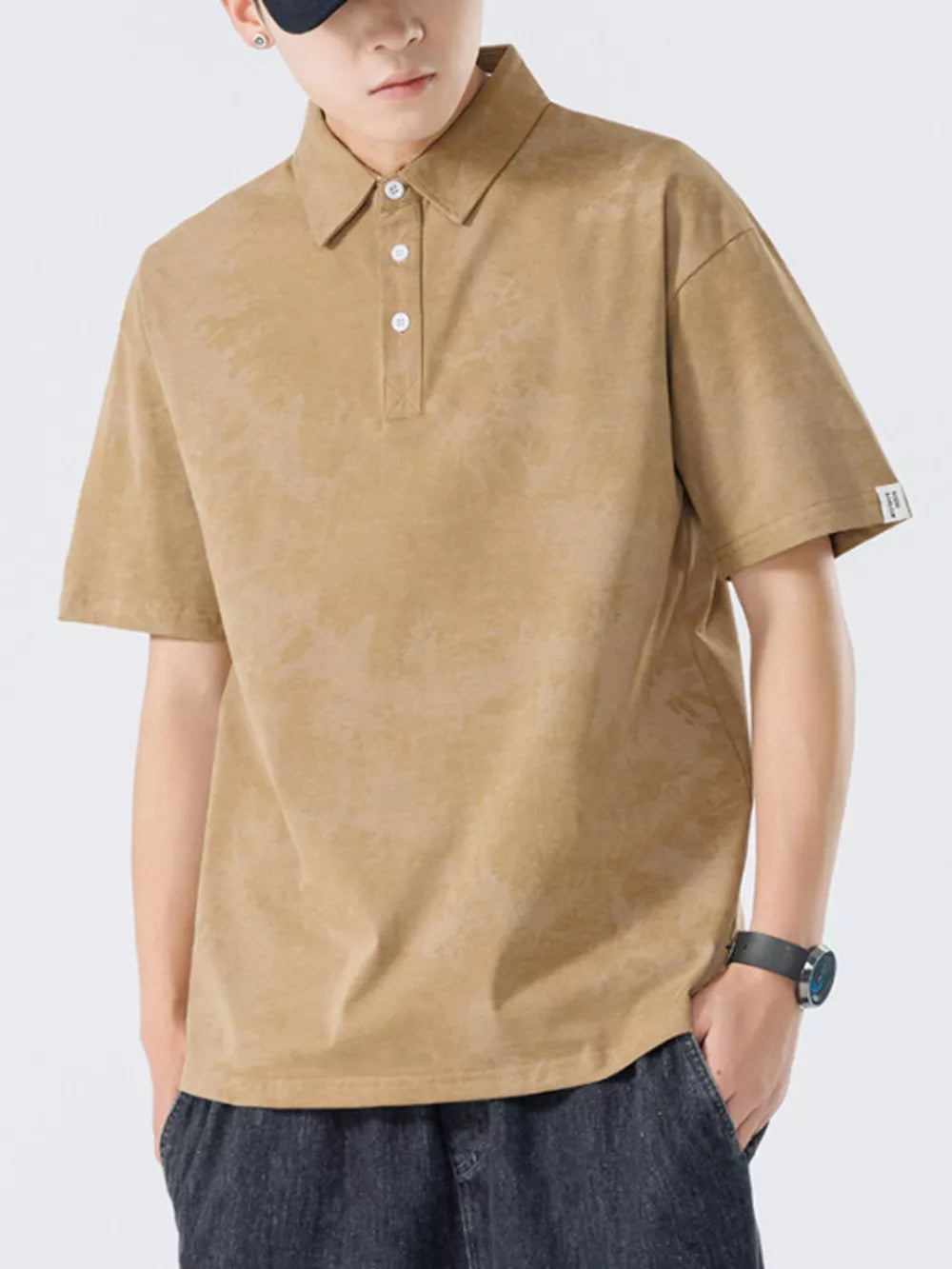 Brown cotton polo shirt with subtle texture and buttoned placket.