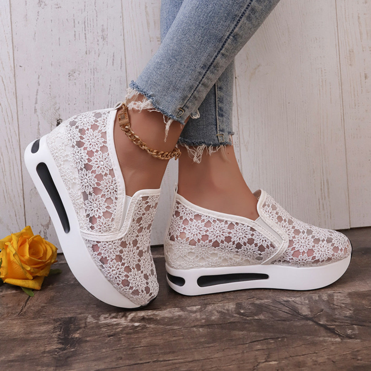 White floral lace slip-on sneakers with chunky soles and breathable mesh detail.