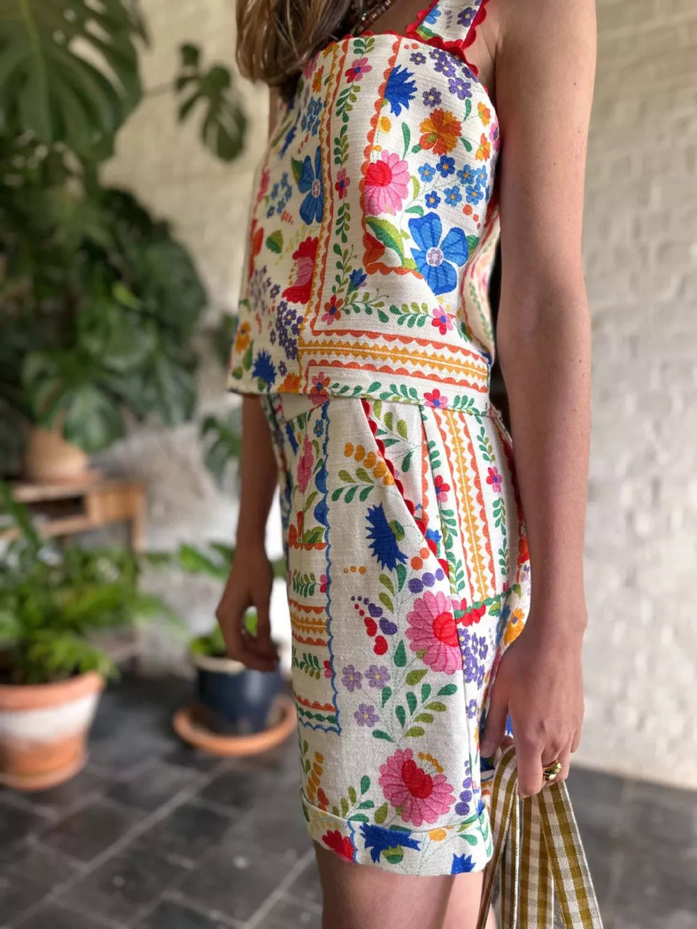 Floral cami and pocketed shorts set with colorful embroidery and scalloped trim.