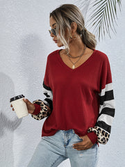 Waffle knit v-neck top in wine with colorblock striped and leopard print sleeves.