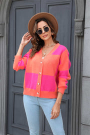 Colorblock geometric knit cardigan with button front in pink and orange acrylic.