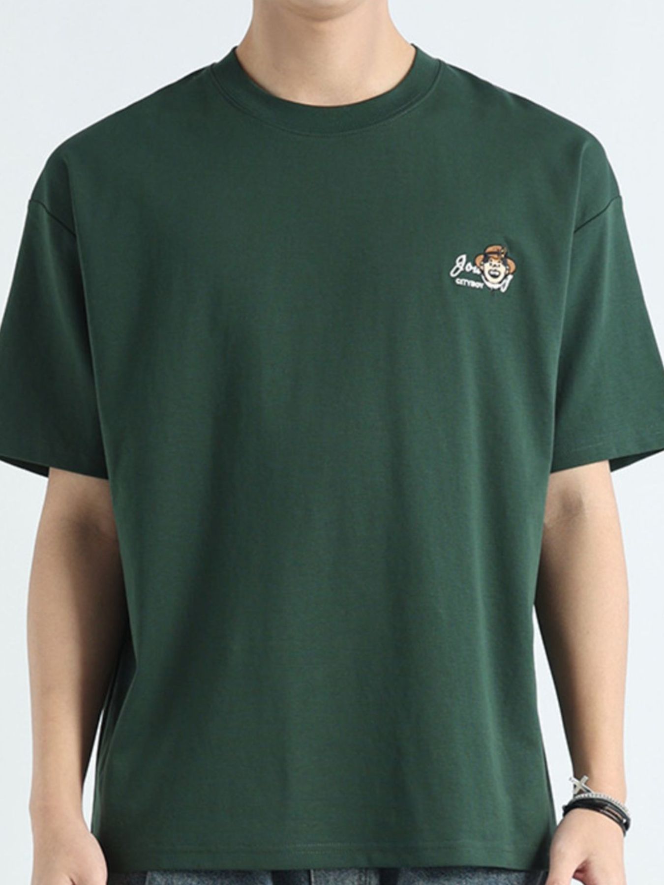 Men's dark green cotton t-shirt with a round neck and small embroidered monkey graphic.