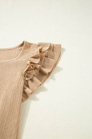 Tan textured blouse with ruffled cap sleeves and square neckline.