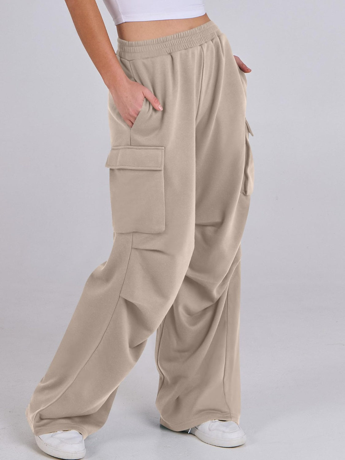 Tan sweatpants with cargo pockets and a wide leg cut.