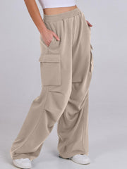 Tan sweatpants with cargo pockets and a wide leg cut.