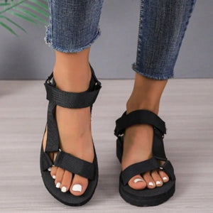 Black platform sandals with adjustable straps and a thick sole.
