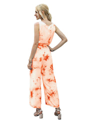 Sleeveless orange tie-dye jumpsuit with wide legs and a belted waist.