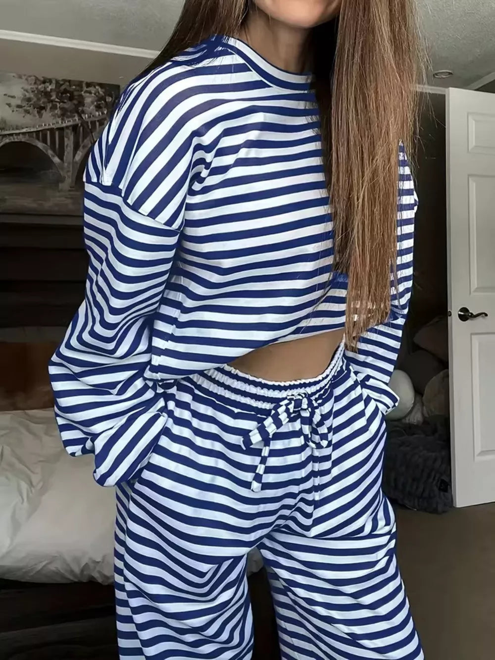 Royal blue and white striped pajama set with drawstring pants and long sleeves.
