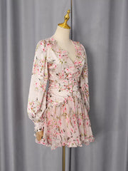 Charming floral mini dress with ruffles, V-neck, and long sleeves.