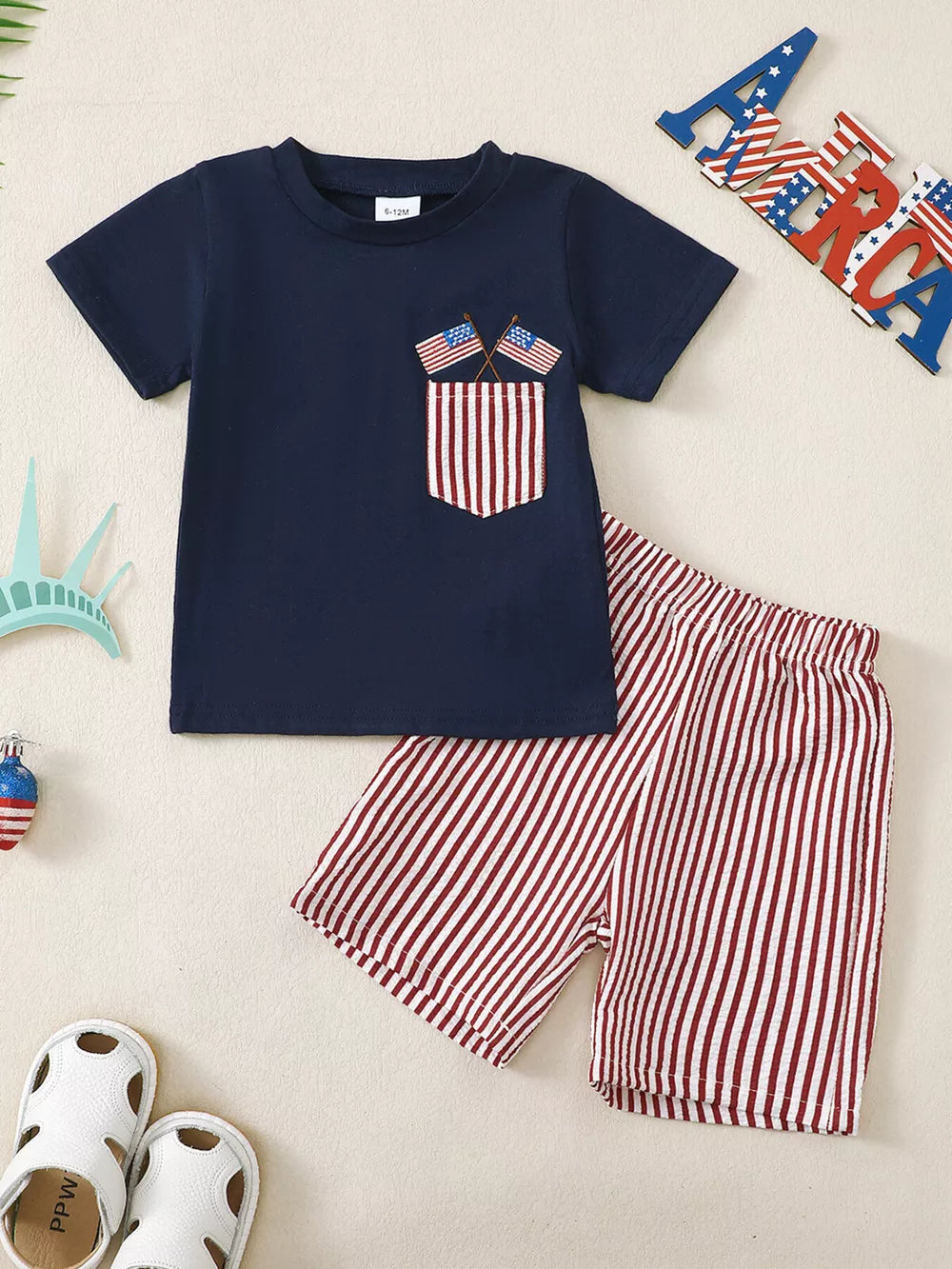 Navy patriotic pocket tee with American flag detail and red striped shorts set.