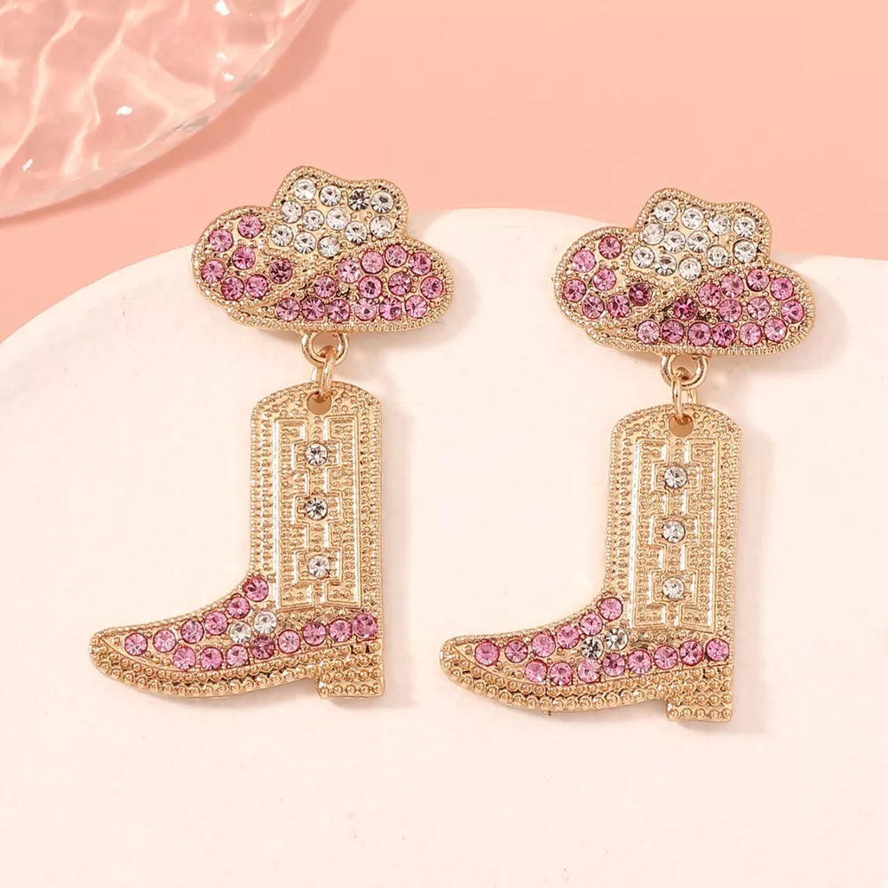 Rhinestone cowboy boot dangle earrings with pink and white crystals.