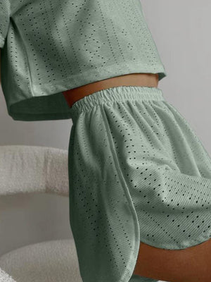 Sage perforated crop top and shorts set with elastic waistband and breathable fabric.