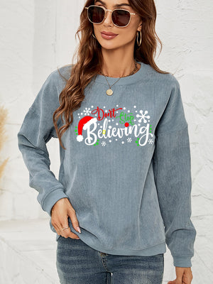 Misty Blue corduroy crewneck sweatshirt with a Christmas graphic that says "Don't Stop Believing.